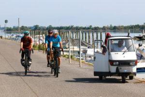 Cyclists taking over the Piaggio Ape in Italy.