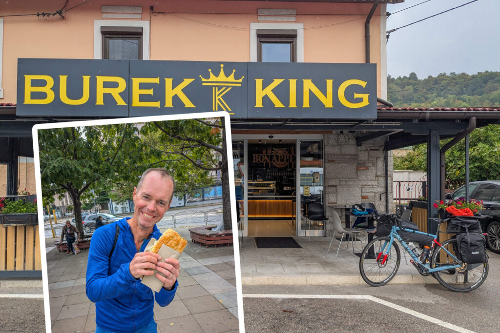 Cyclist trying out burek on Trans Dinarica.